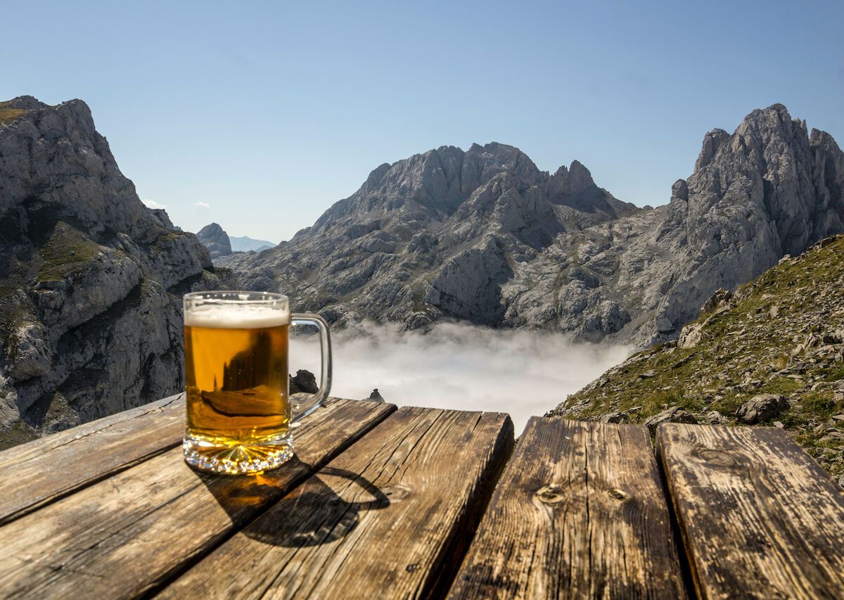 beer outside on a park bench overlooking mountains